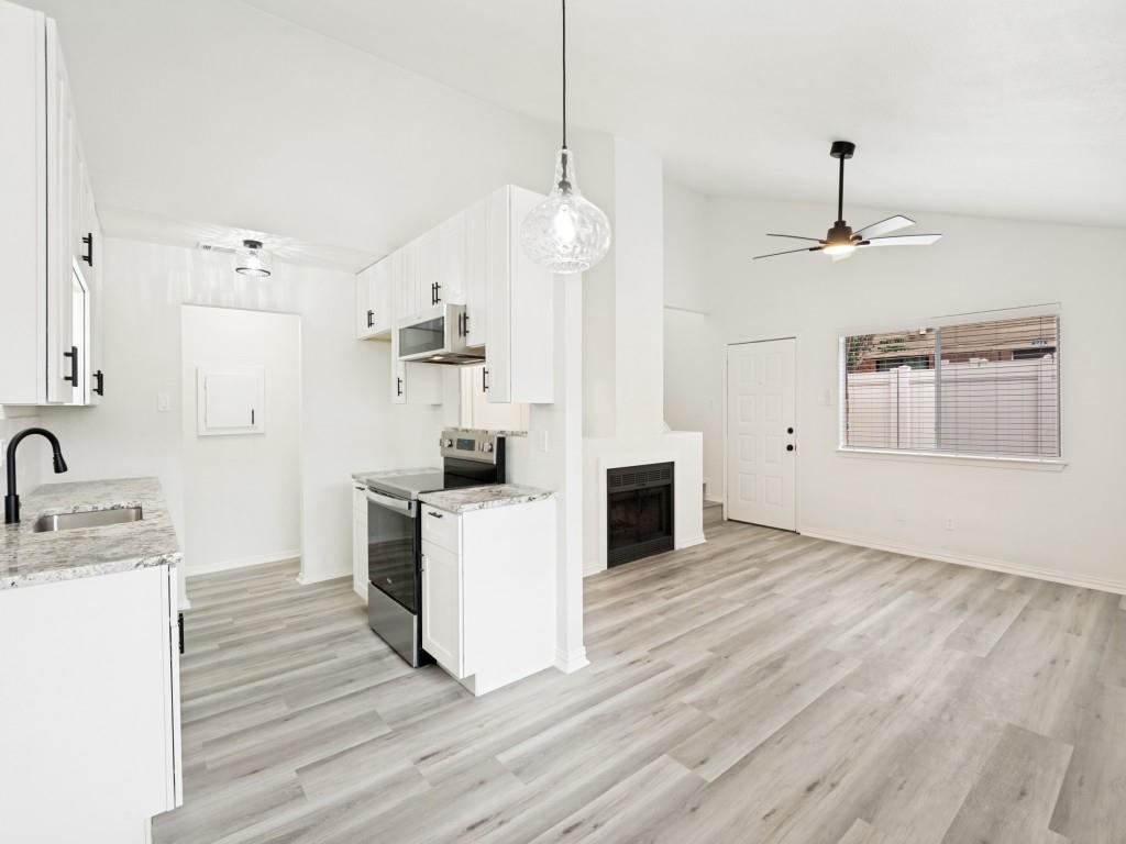 2240 Tarpley Road, Unit 92 Carrollton, TX 75006 - Photo 4 of 22 a kitchen with kitchen island a sink stainless steel appliances and cabinets