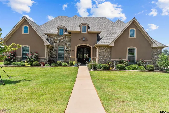 a front view of a house with garden