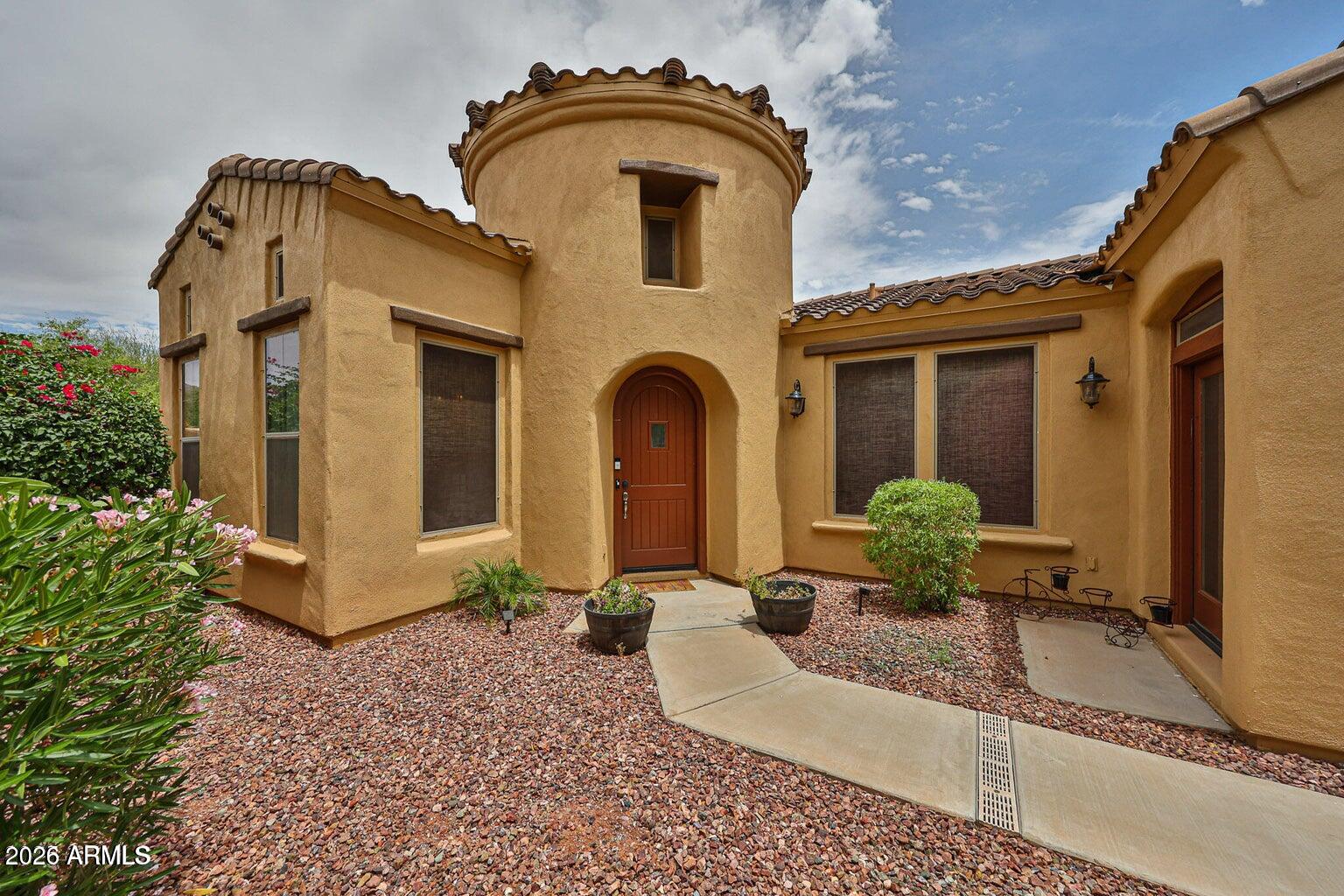 3950 North Edith Way Buckeye, AZ 85396 - Photo 3 of 32 a front view of a house with garden