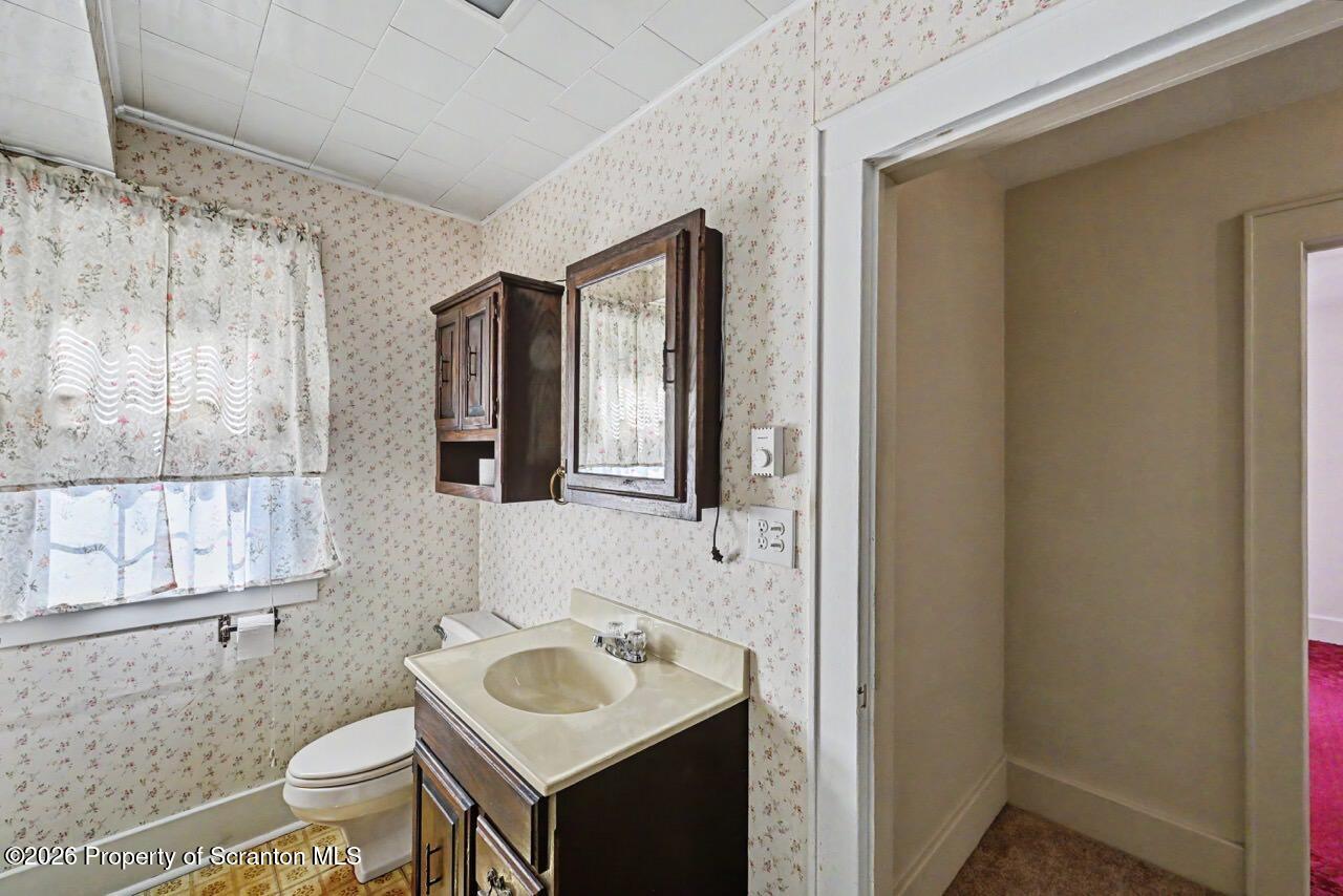 502 Layton Road Clarks Summit, PA 18411 - Photo 30 of 42 a bathroom with a toilet sink and mirror