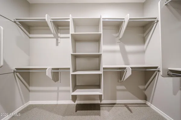 a view of walk in closet with empty racks