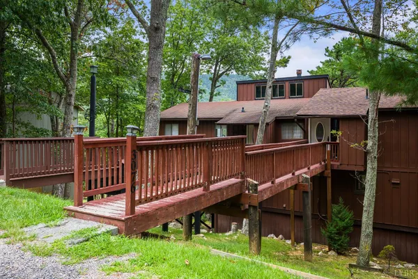 a view of a house with a yard and sitting area