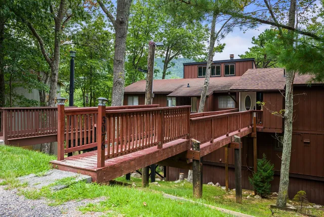 a view of a house with a yard and sitting area