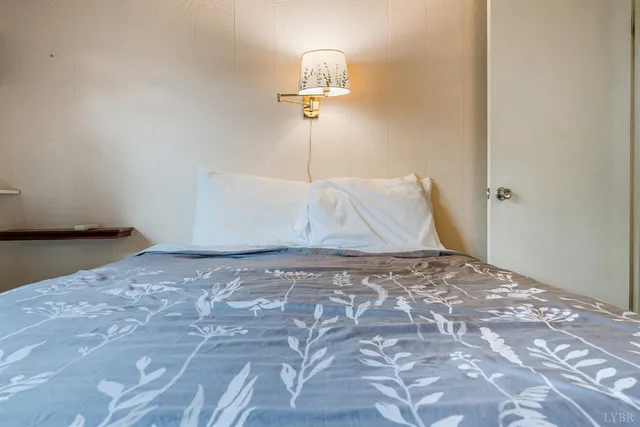 a bedroom with bed and a window