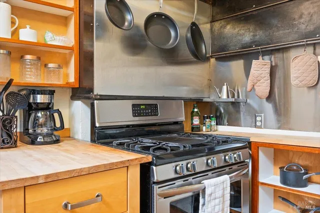 a bedroom with a bed and a dresser next to a window