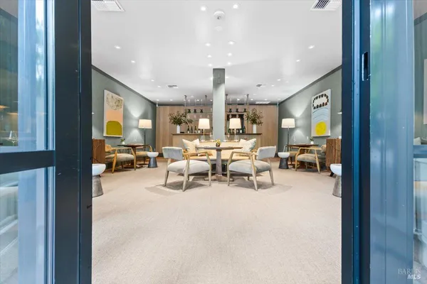 a living room with furniture a rug and a large window