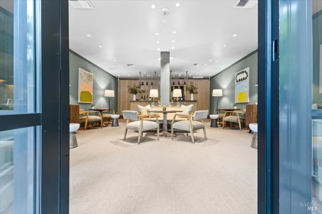a living room with furniture a rug and a large window