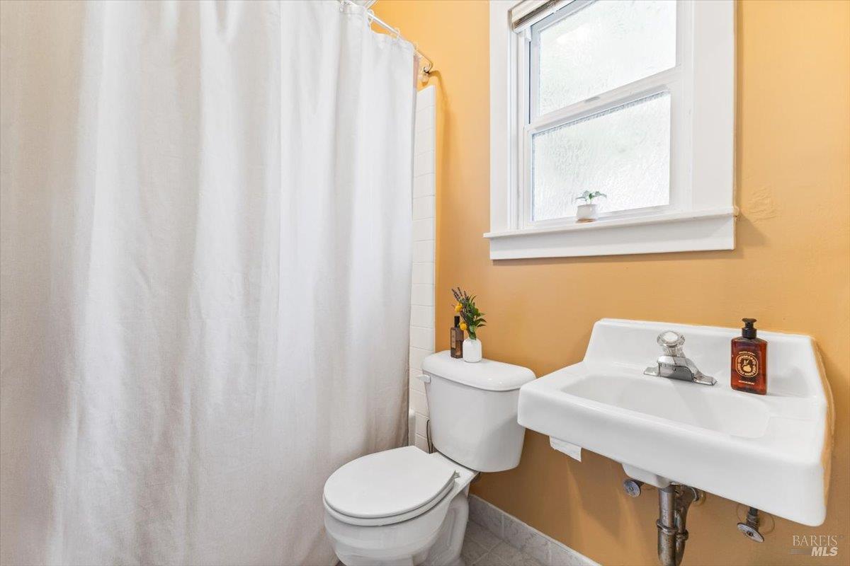 320 Center Street Healdsburg, CA 95448 - Photo 53 of 56 a white toilet sitting next to a bathroom sink