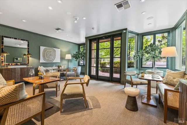a living room with lots of furniture and view of kitchen