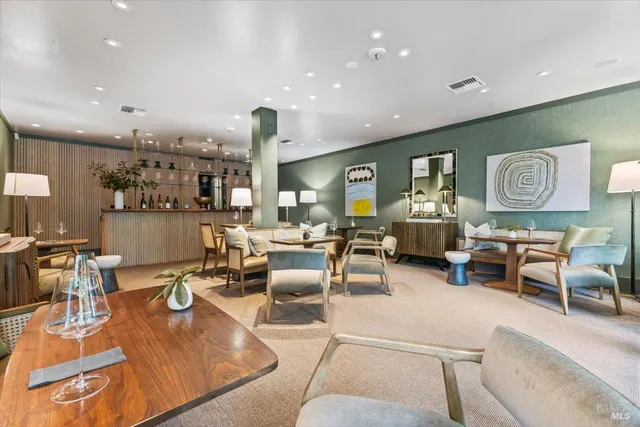 a living room with furniture and a floor to ceiling window