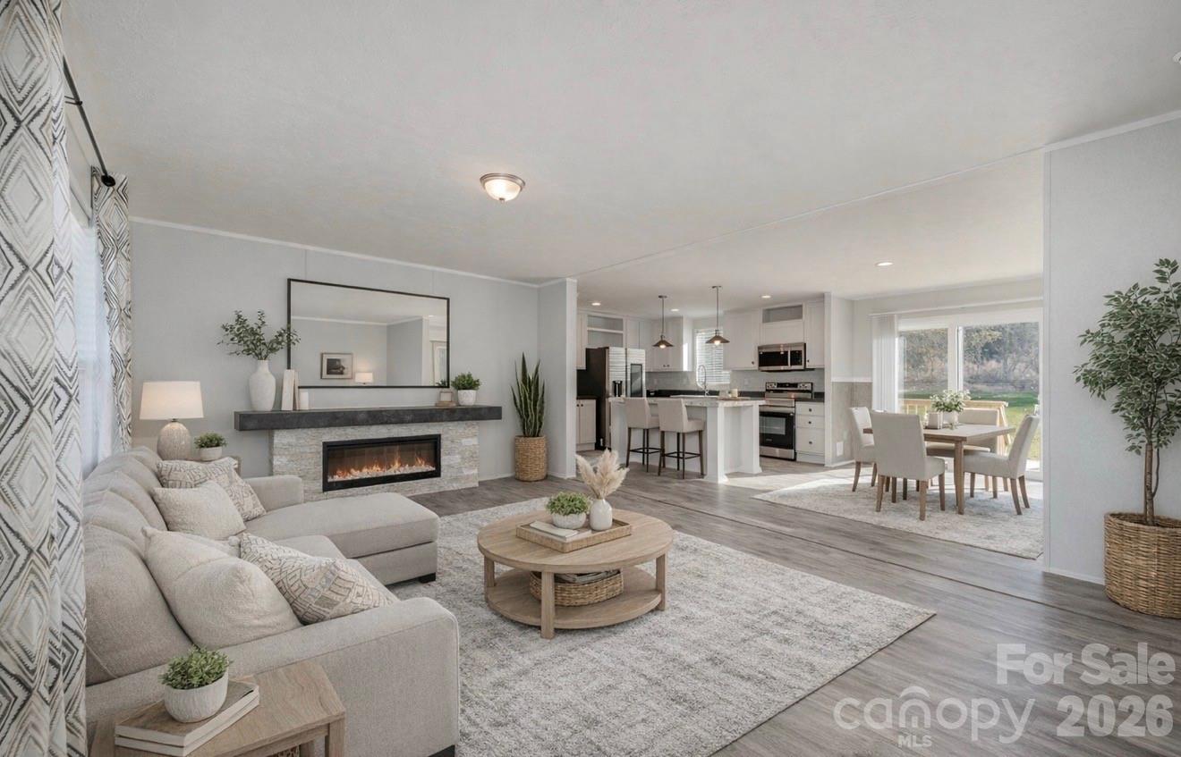 a living room with furniture and a dining table