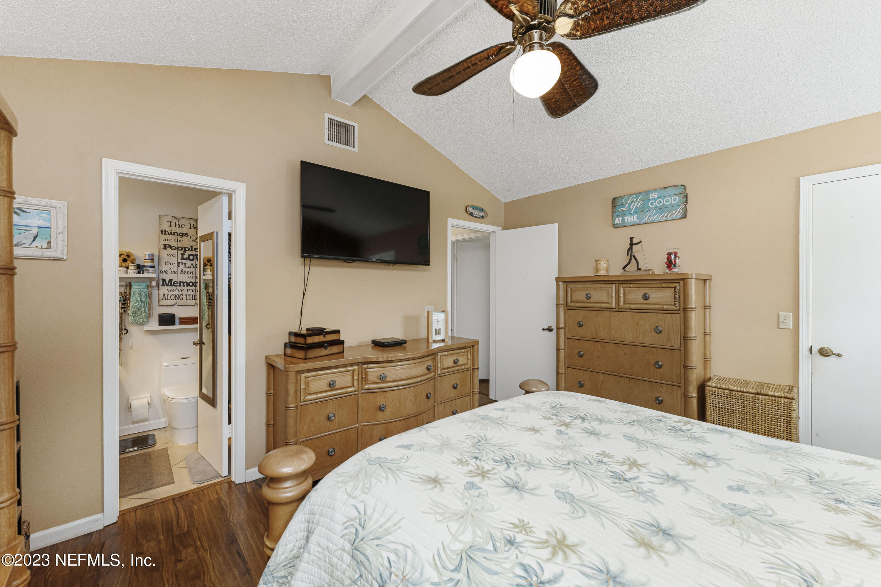 1676 Westwind Drive Jacksonville Beach, FL 32250 - Photo 13 of 42 a bedroom with a bed and a flat screen tv