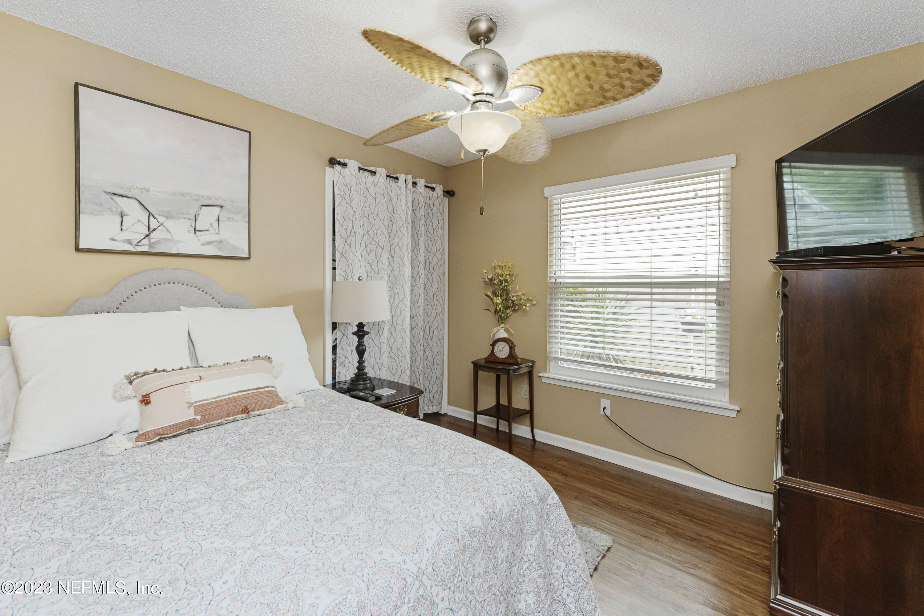 1676 Westwind Drive Jacksonville Beach, FL 32250 - Photo 16 of 42 a bedroom with a bed and a chandelier