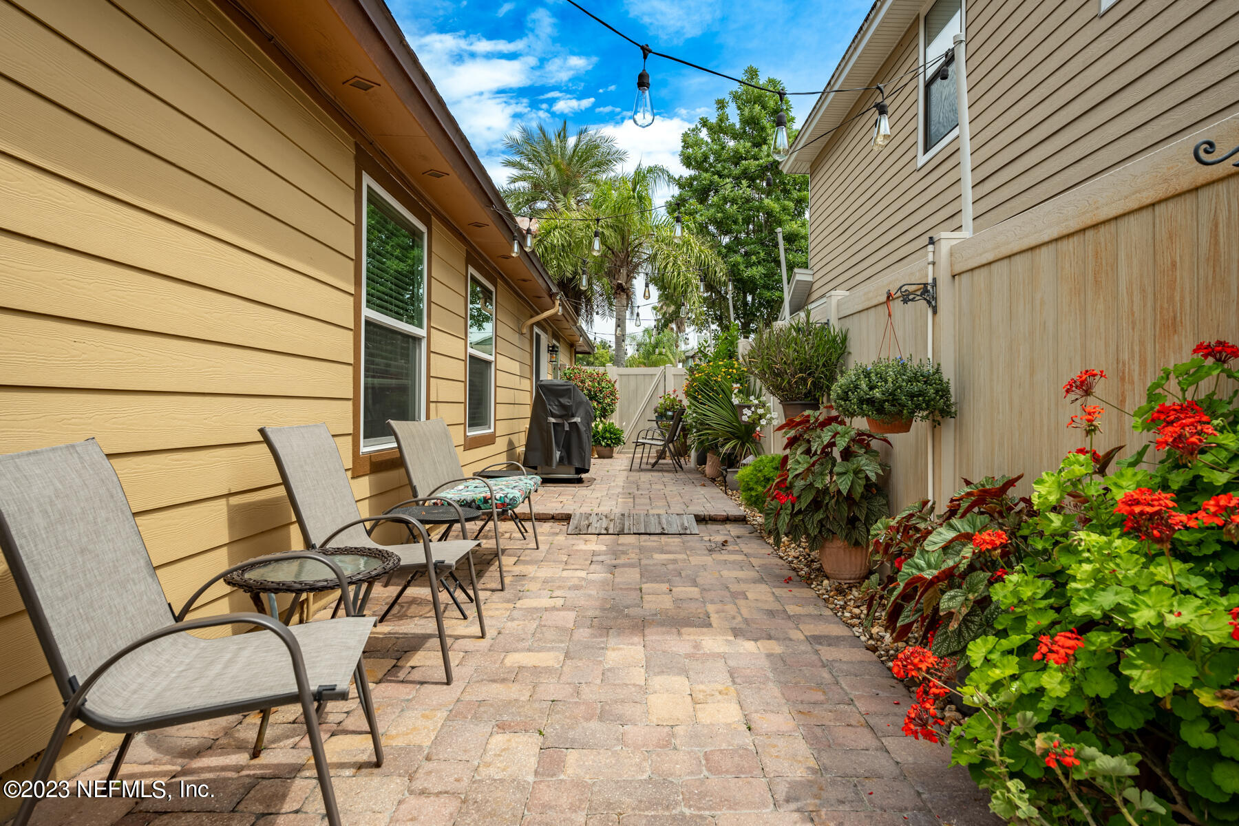 1676 Westwind Drive Jacksonville Beach, FL 32250 - Photo 21 of 42 a view of patio with a table and chairs and potted plants