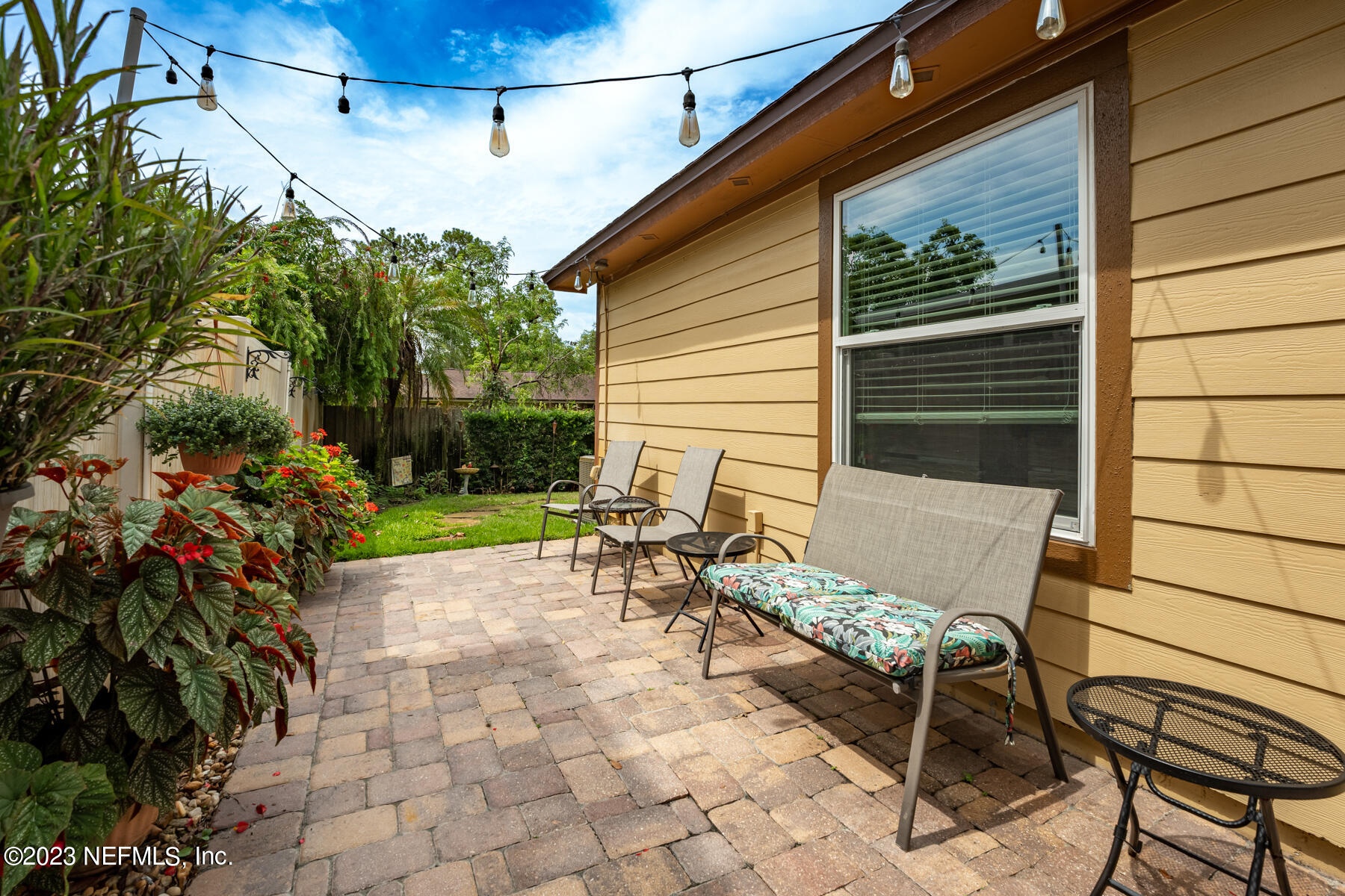 1676 Westwind Drive Jacksonville Beach, FL 32250 - Photo 22 of 42 a view of a patio with table and chairs and potted plants