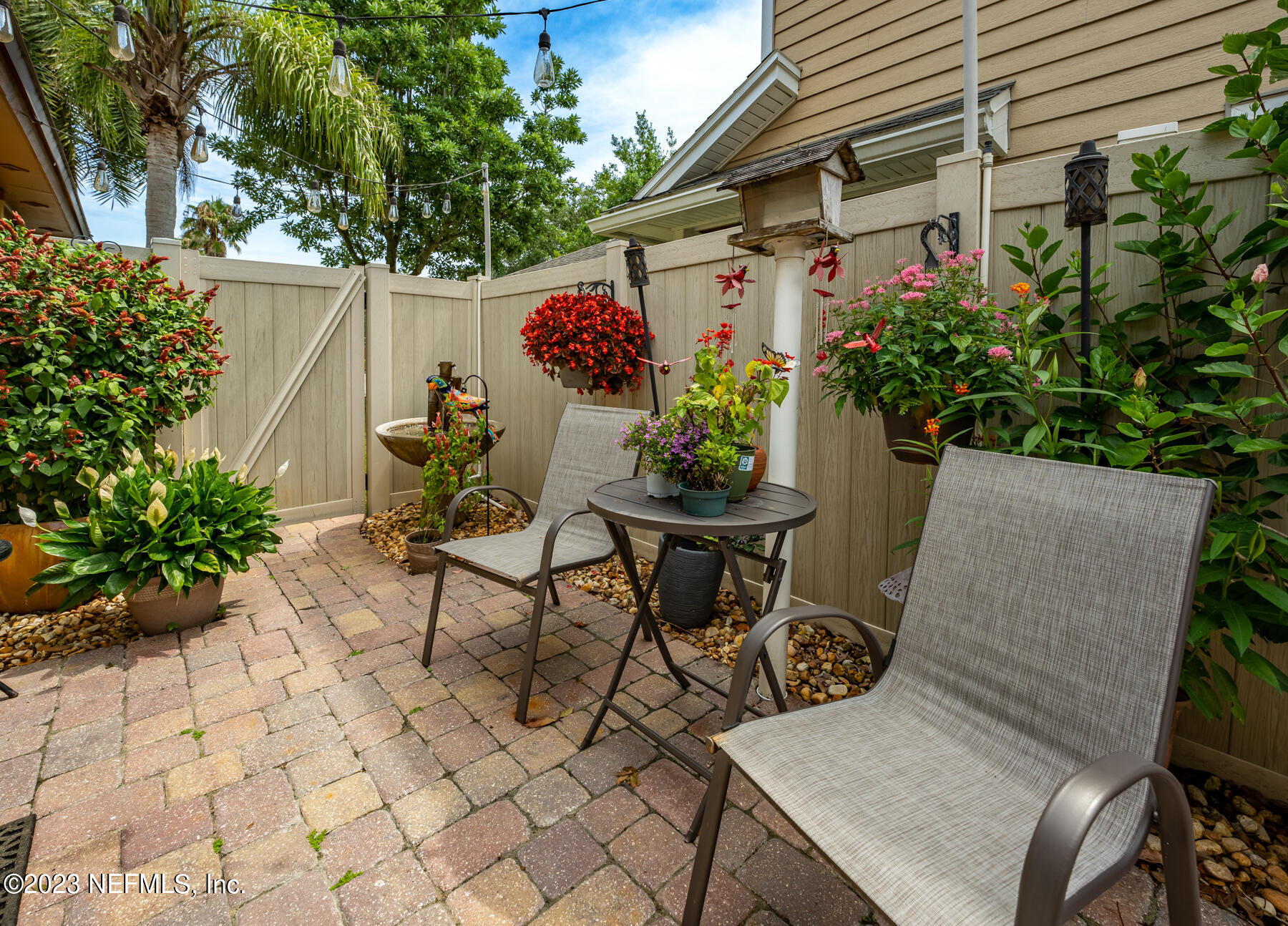 1676 Westwind Drive Jacksonville Beach, FL 32250 - Photo 23 of 42 a view of a chairs and table in a backyard