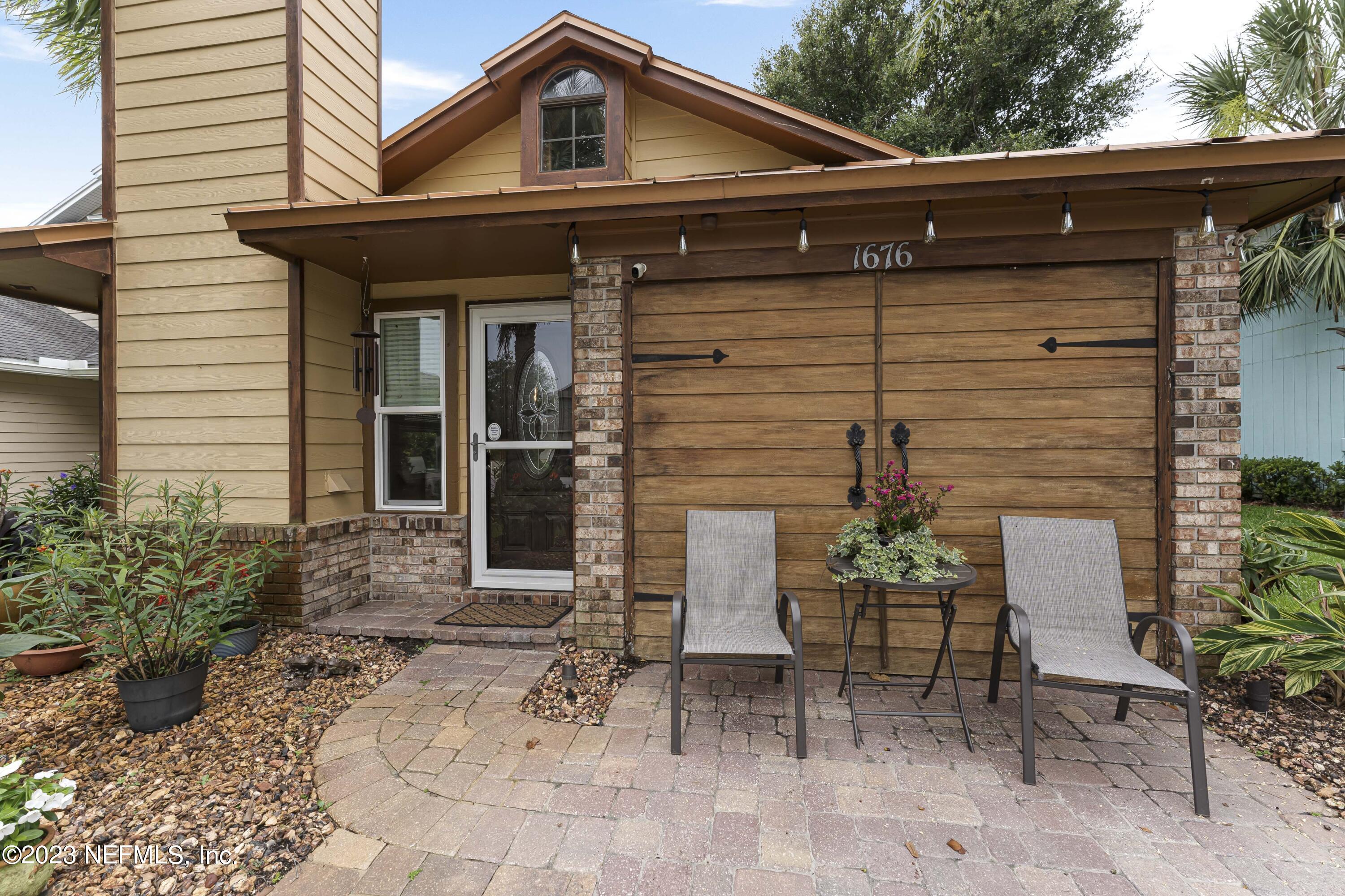 1676 Westwind Drive Jacksonville Beach, FL 32250 - Photo 26 of 42 a front view of a house with garden