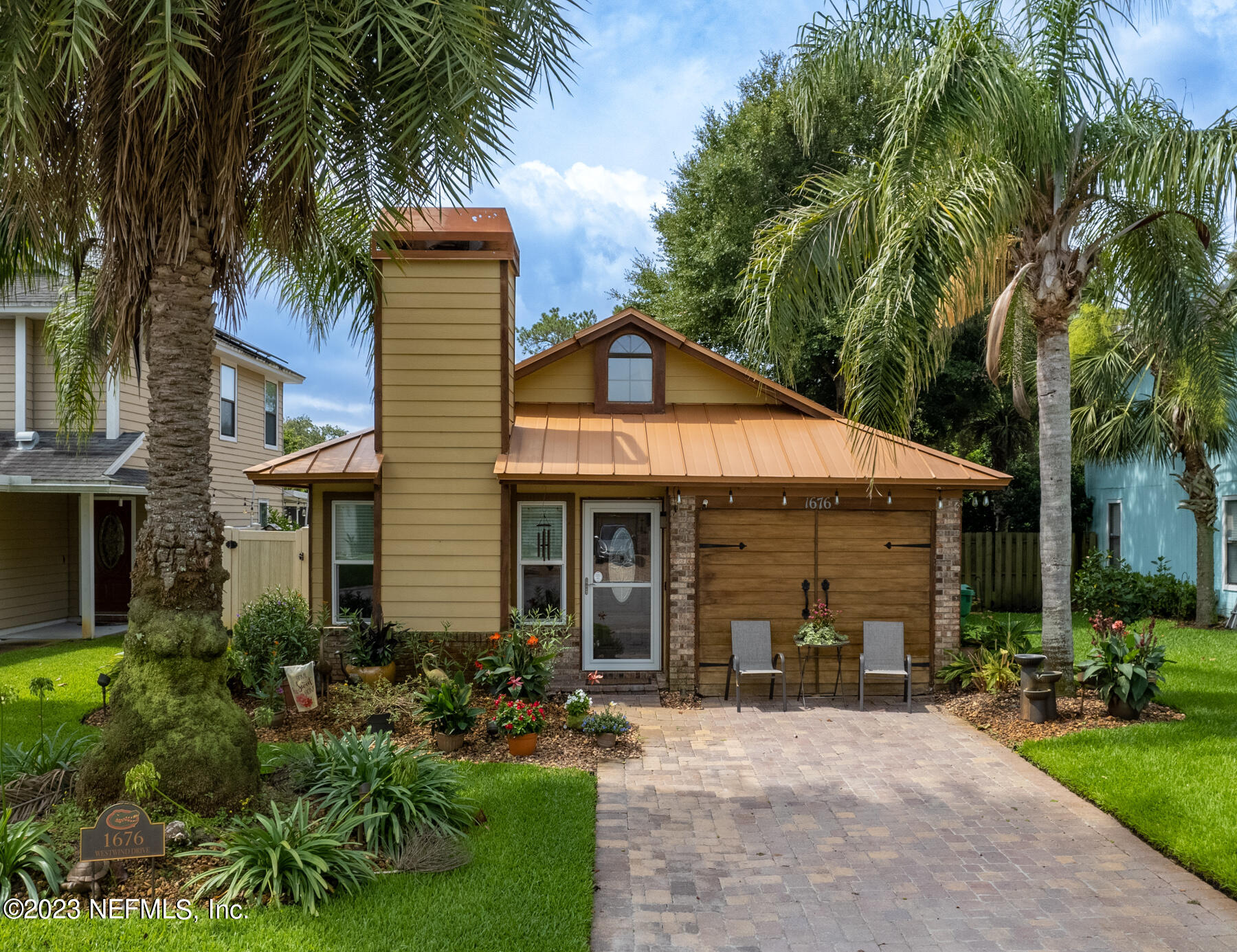 1676 Westwind Drive Jacksonville Beach, FL 32250 - Photo 3 of 42 a front view of a house with a garden