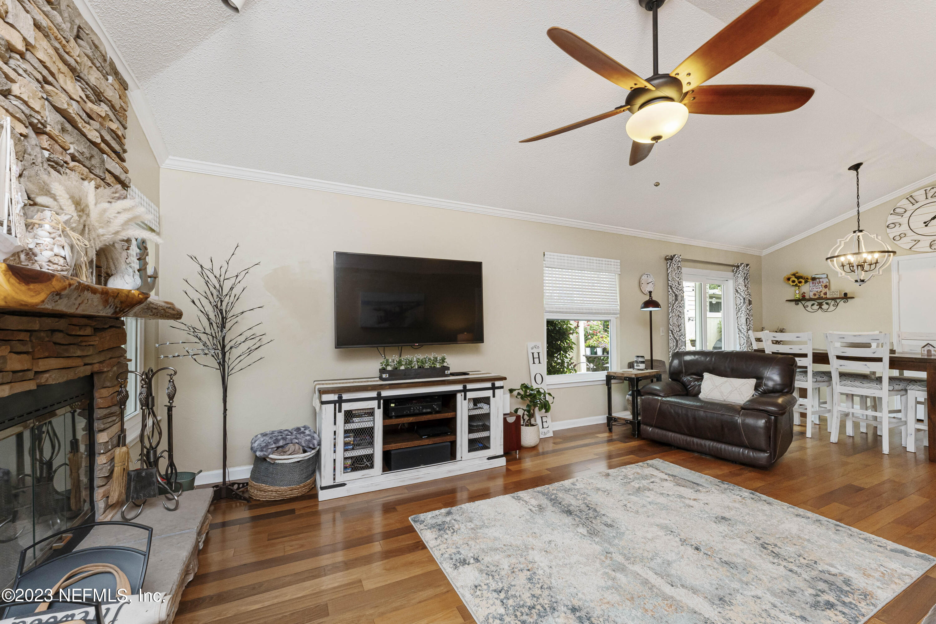 1676 Westwind Drive Jacksonville Beach, FL 32250 - Photo 6 of 42 a living room with furniture and a flat screen tv