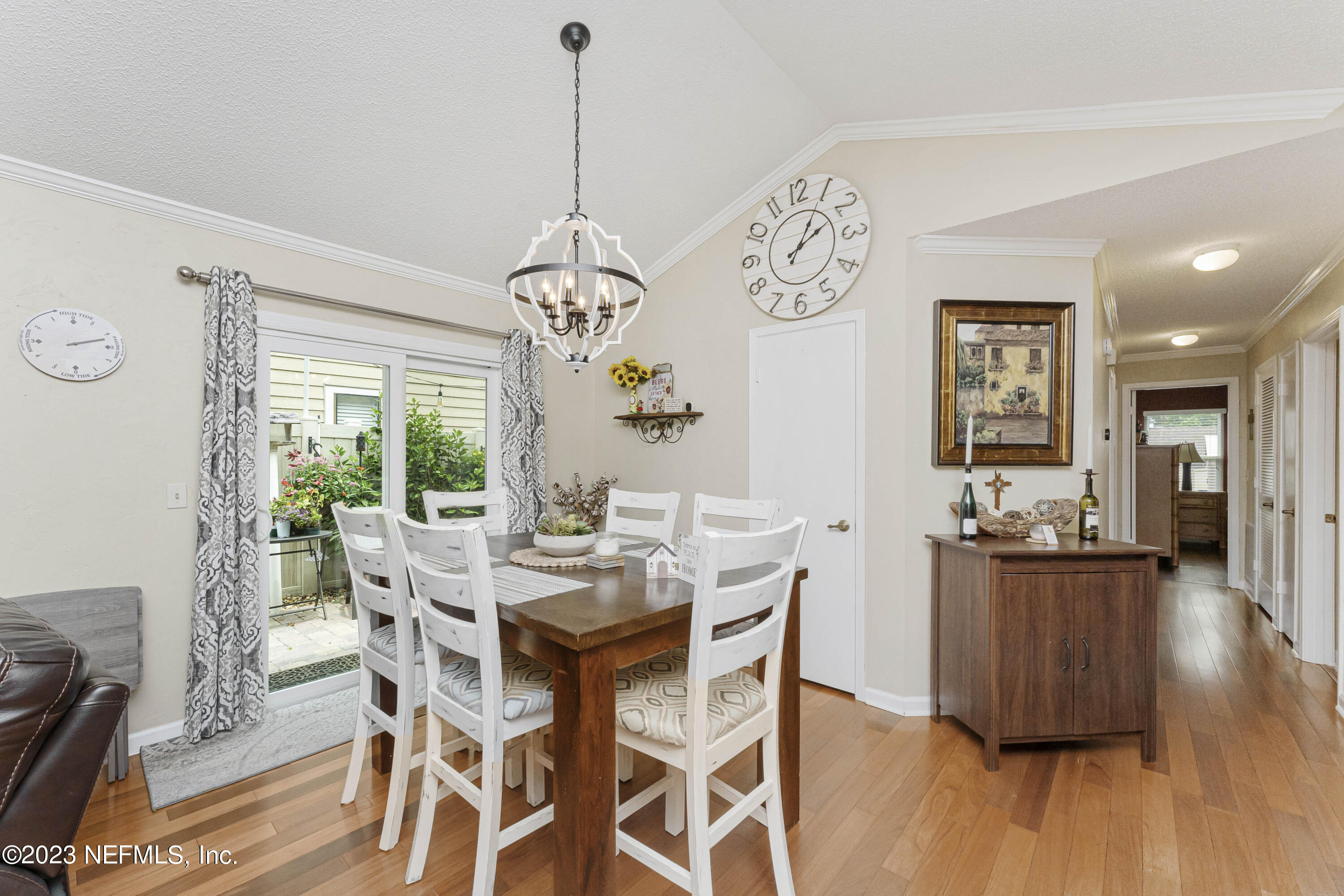 1676 Westwind Drive Jacksonville Beach, FL 32250 - Photo 7 of 42 a view of a dining room with furniture wooden floor and chandelier