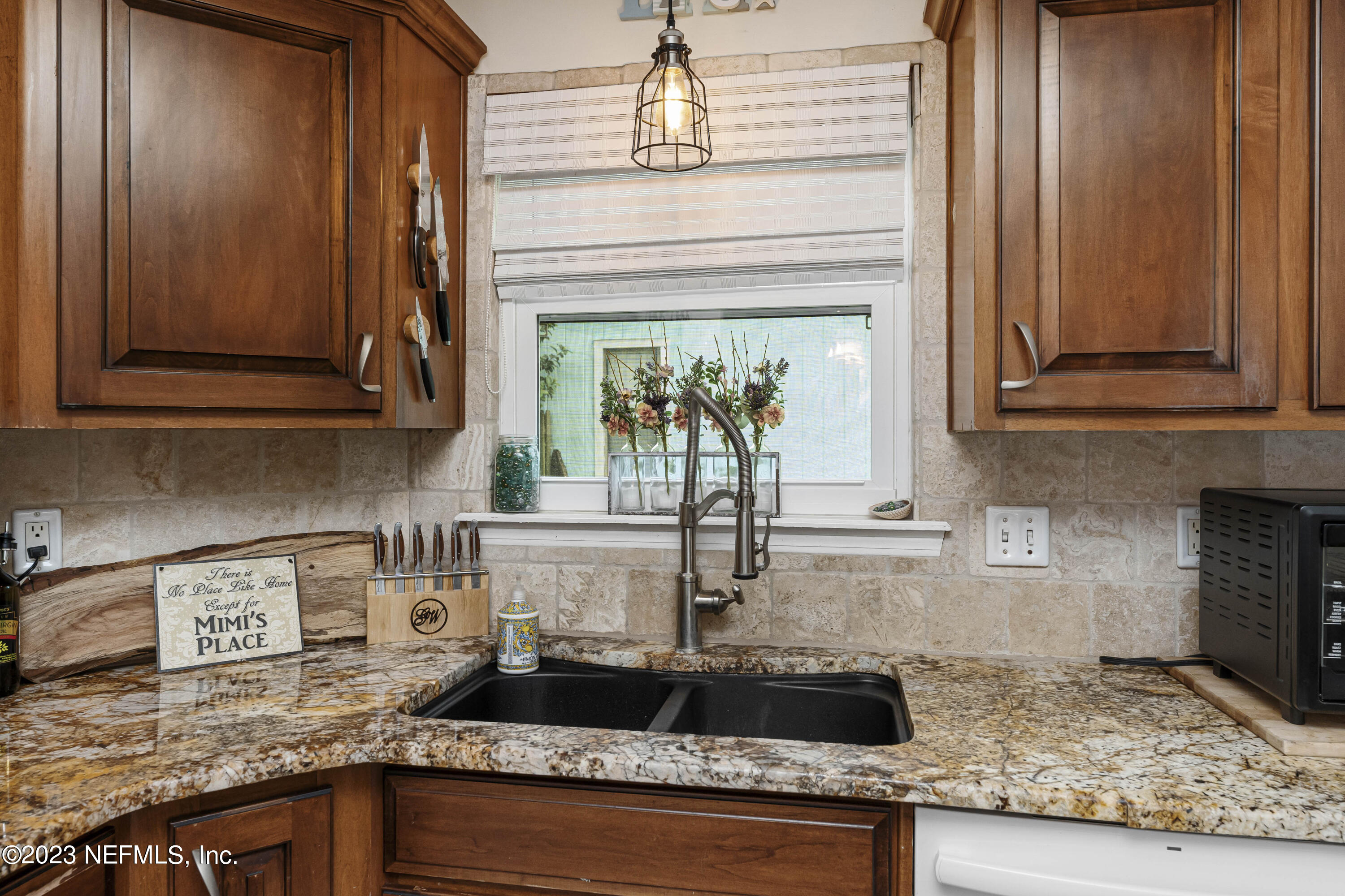 1676 Westwind Drive Jacksonville Beach, FL 32250 - Photo 9 of 42 a kitchen with granite countertop stainless steel appliances stove top oven and cabinets