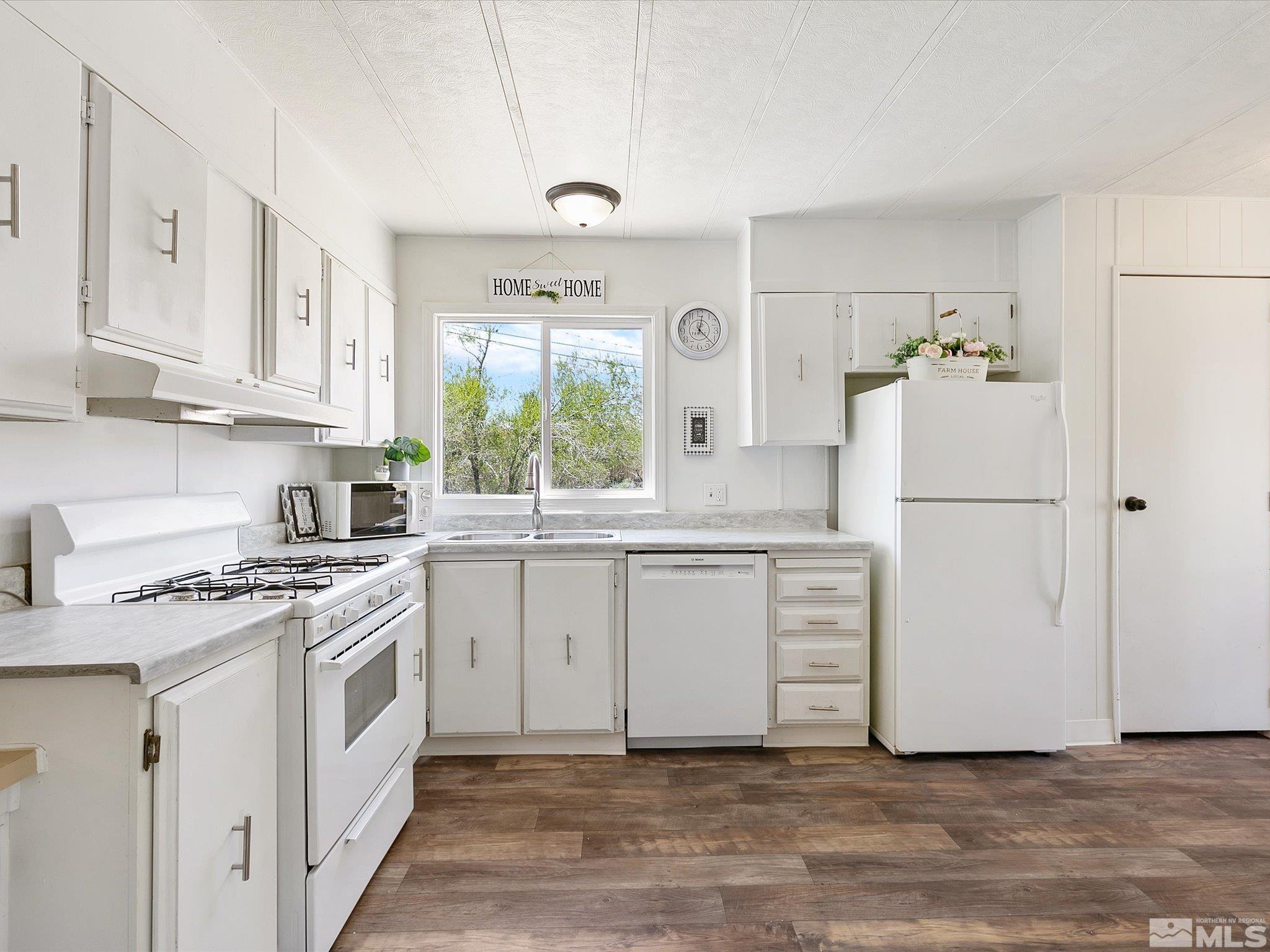 17560 Thrush Lane Reno, NV 89508 - Photo 1 of 27 a kitchen with white cabinets and white appliances