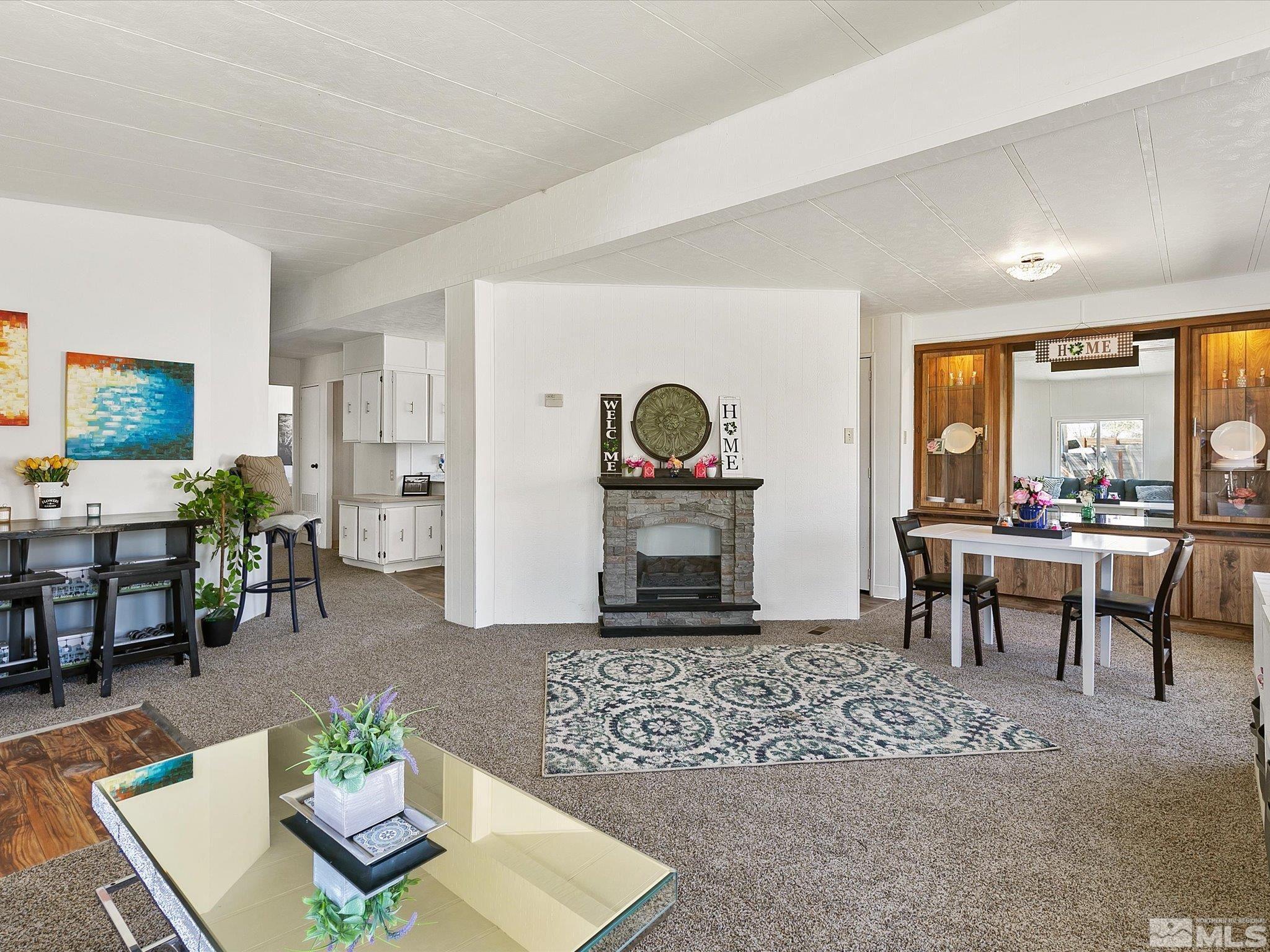 17560 Thrush Lane Reno, NV 89508 - Photo 11 of 27 a living room with furniture a fireplace and a table