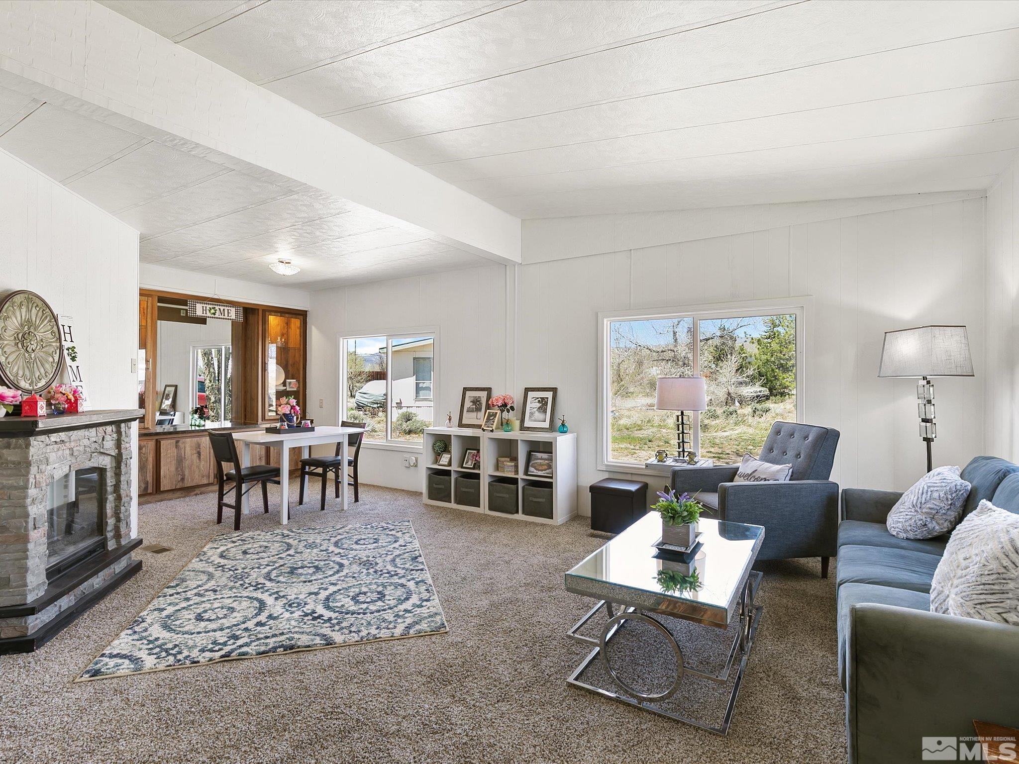 17560 Thrush Lane Reno, NV 89508 - Photo 12 of 27 a living room with furniture a window and a fireplace