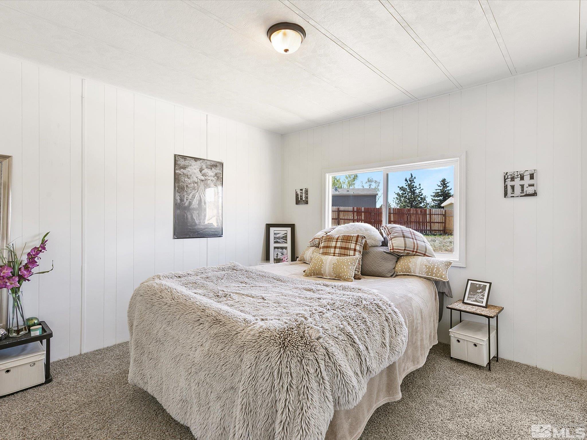 17560 Thrush Lane Reno, NV 89508 - Photo 19 of 27 a bedroom with double bed and a potted plant