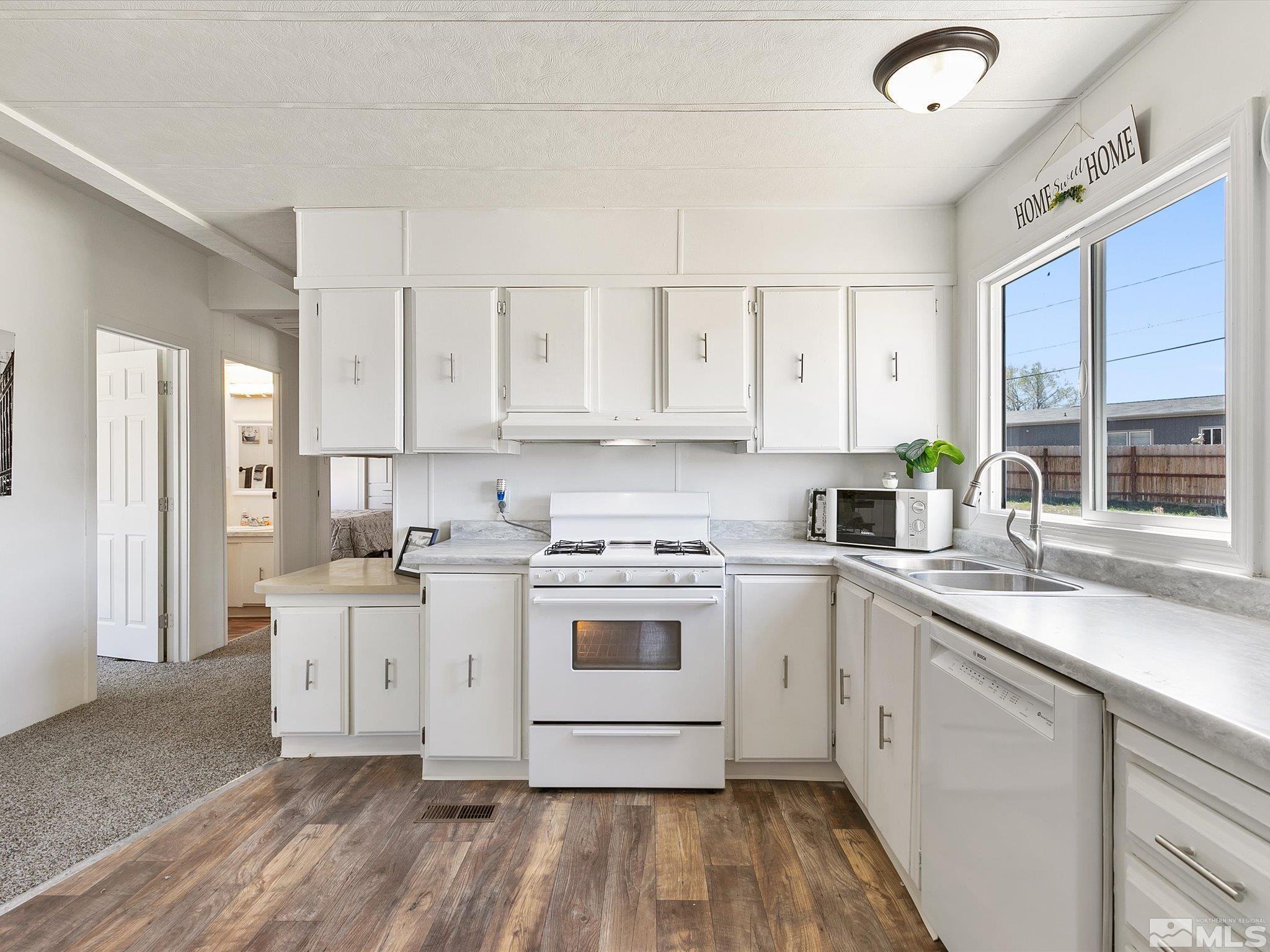 17560 Thrush Lane Reno, NV 89508 - Photo 6 of 27 a kitchen with stainless steel appliances granite countertop a stove a sink dishwasher and a refrigerator