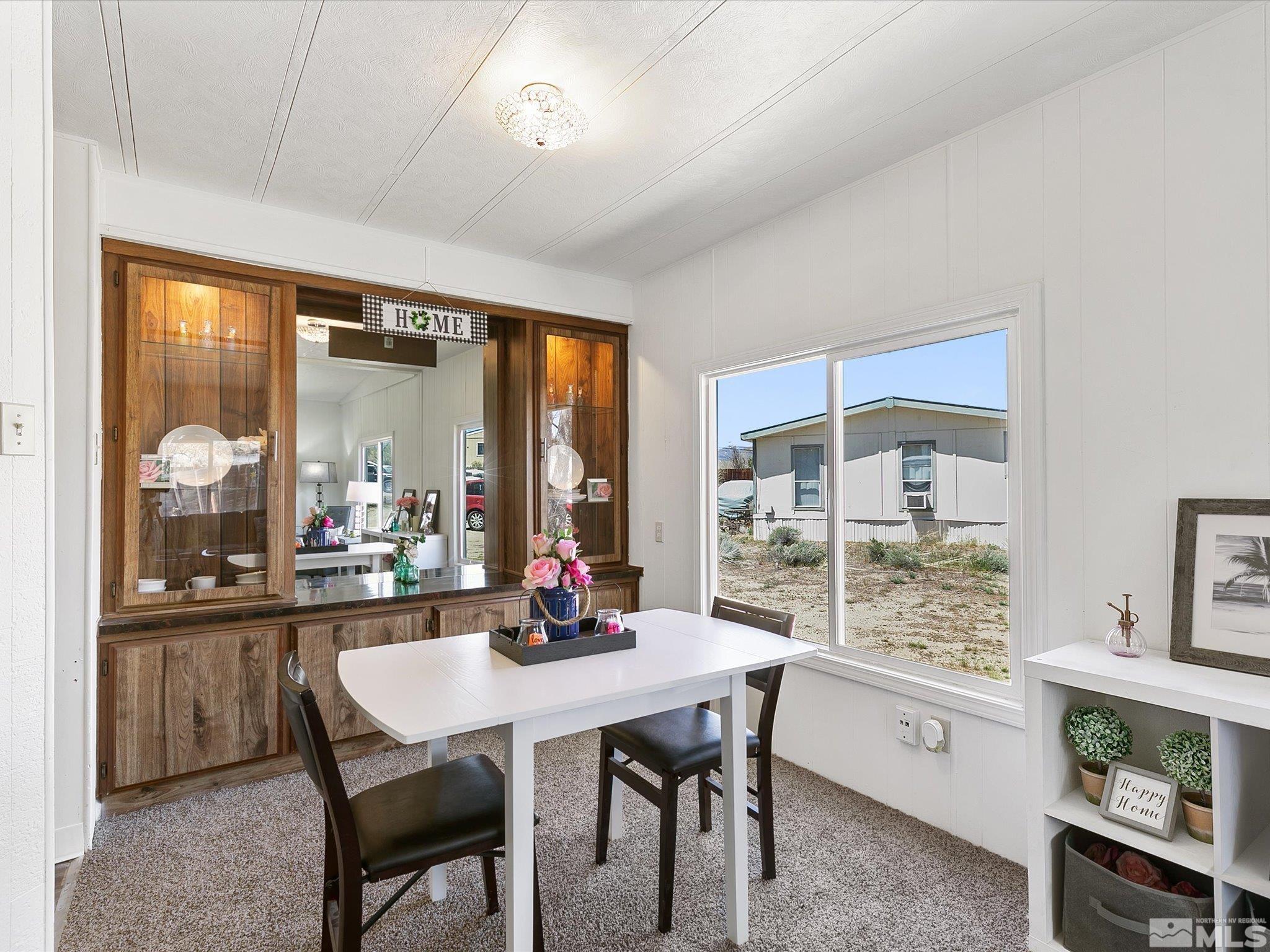 17560 Thrush Lane Reno, NV 89508 - Photo 9 of 27 a dining room with furniture a chandelier and window