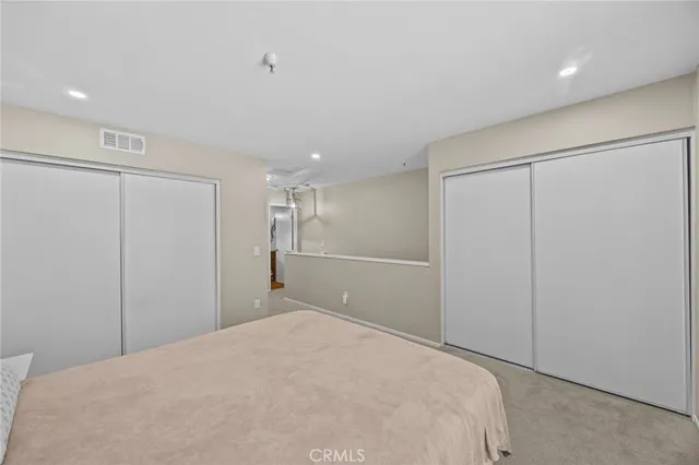 a bedroom with a bed and a closet