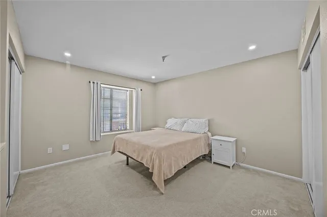 a spacious bedroom with a bed and a window