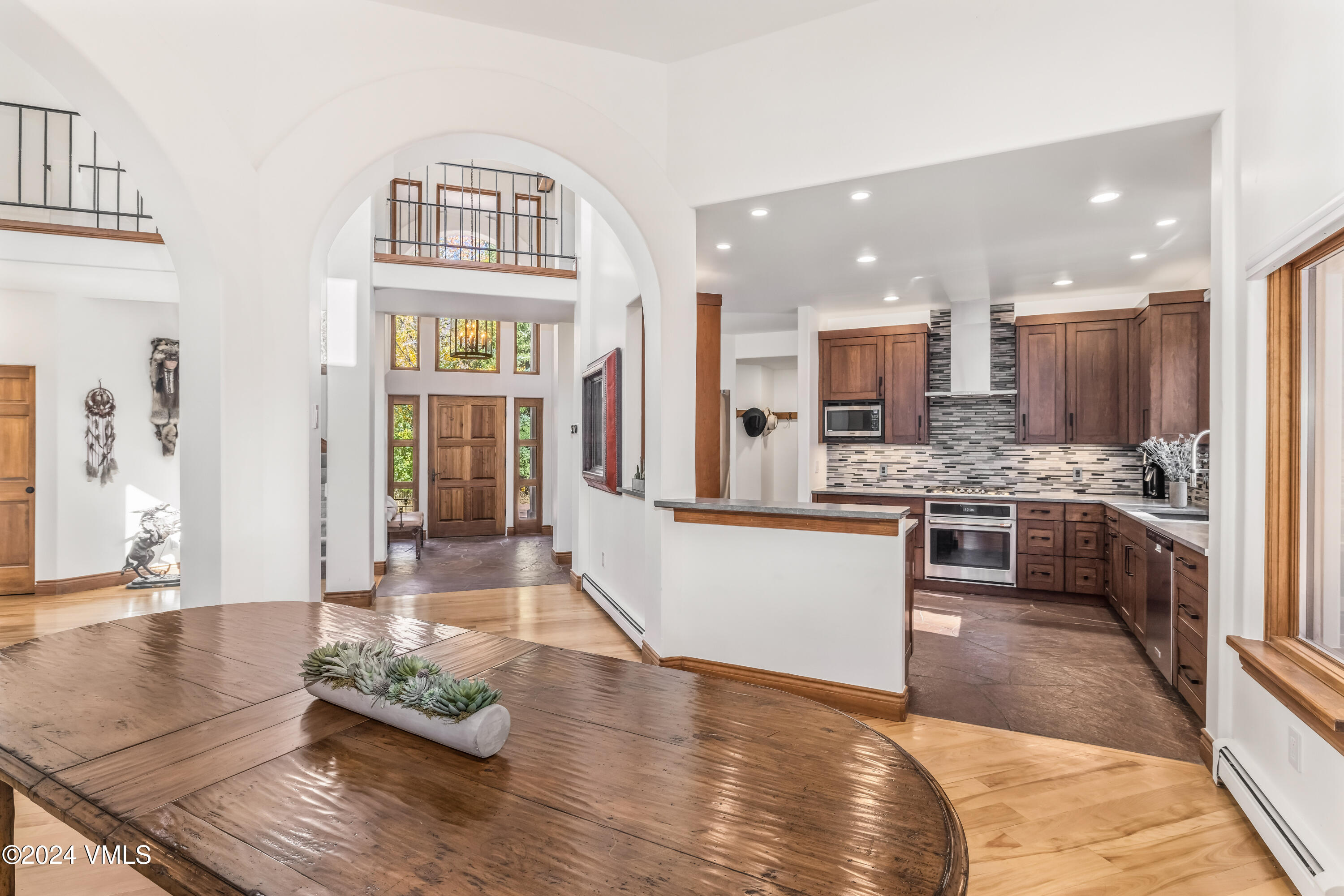 2076 Vermont Road Vail, CO 81657 - Photo 14 of 39 a large white kitchen with kitchen island granite countertop a large counter top stainless steel appliances and cabinets