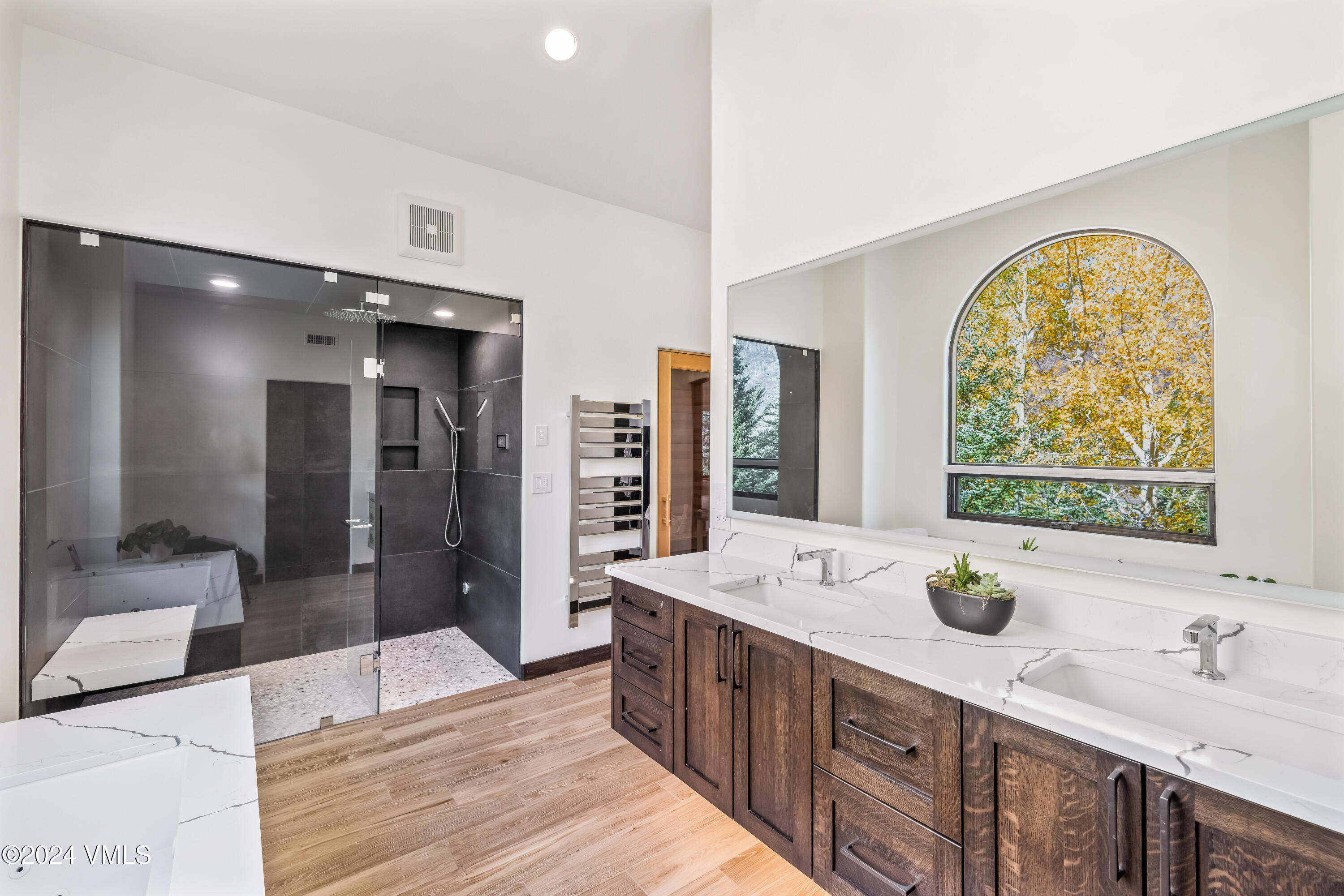 2076 Vermont Road Vail, CO 81657 - Photo 18 of 39 a large bathroom with double vanity sinks a large mirror and shower