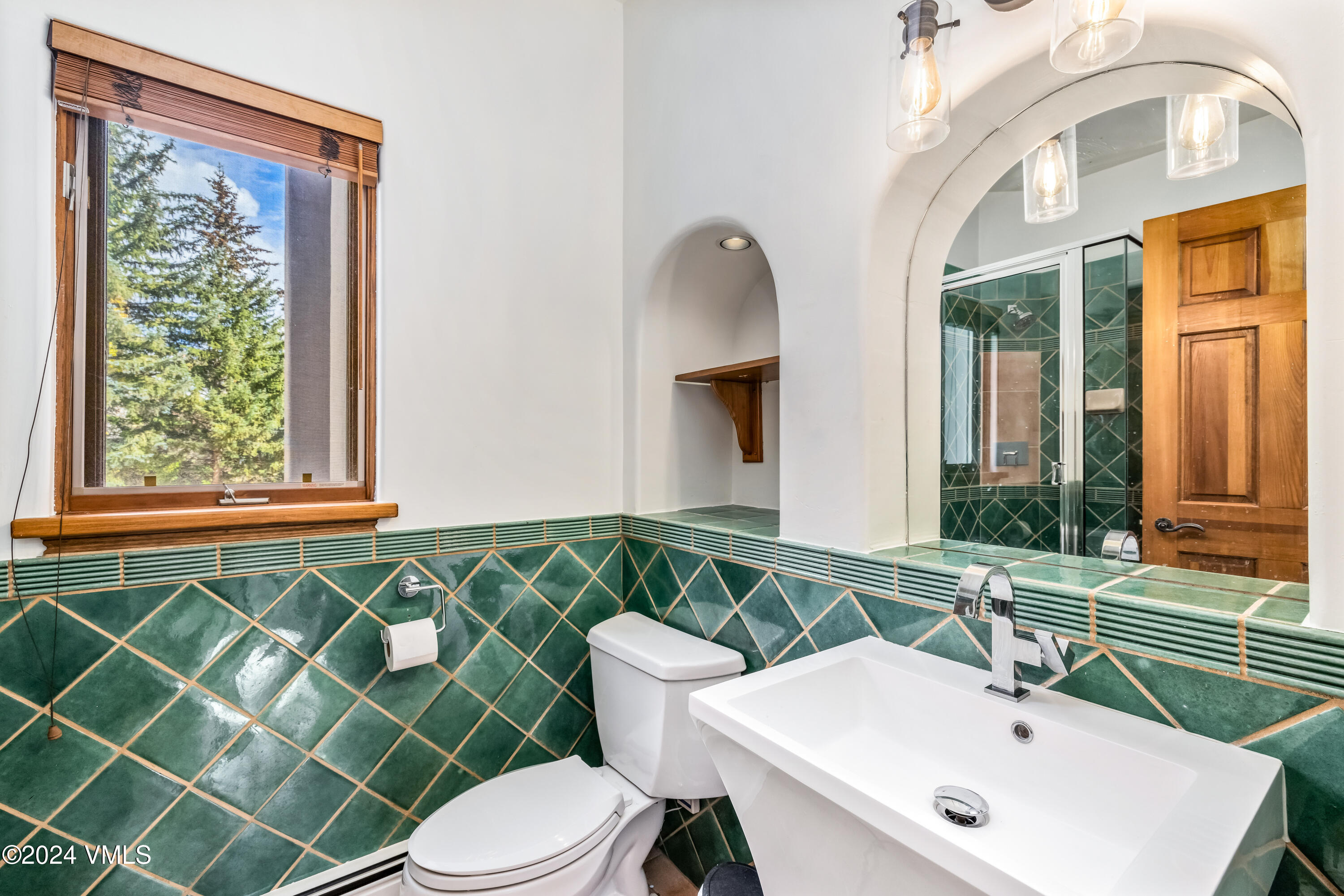 2076 Vermont Road Vail, CO 81657 - Photo 25 of 39 a bathroom with a sink a mirror and a toilet