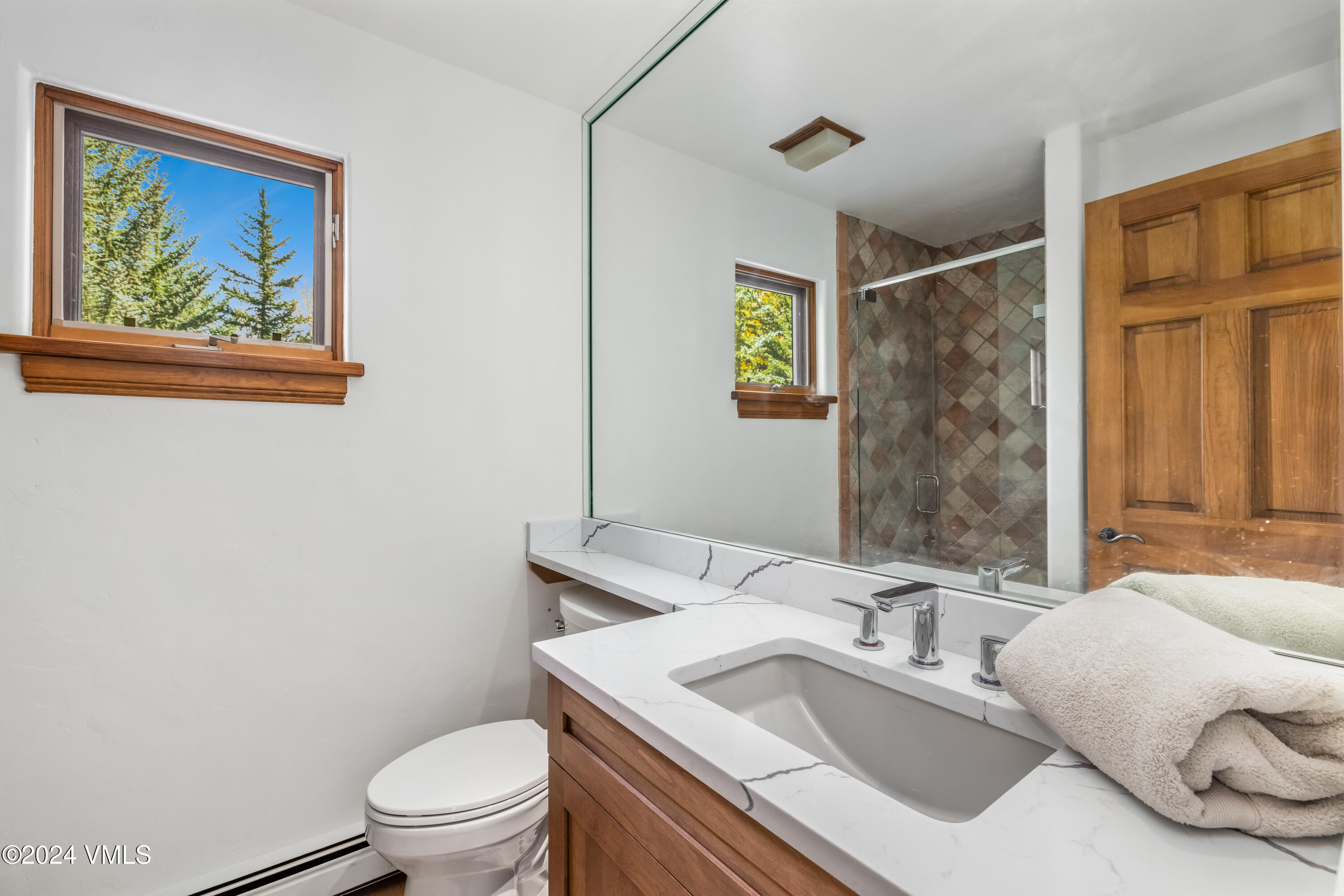 2076 Vermont Road Vail, CO 81657 - Photo 28 of 39 a bathroom with a granite countertop sink mirror vanity and toilet