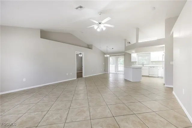 a large white kitchen with a stove a sink dishwasher and a refrigerator