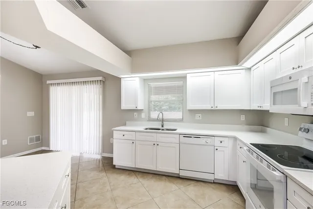 an empty room with closet and windows