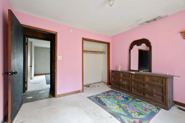 a bedroom with a bed and a dresser