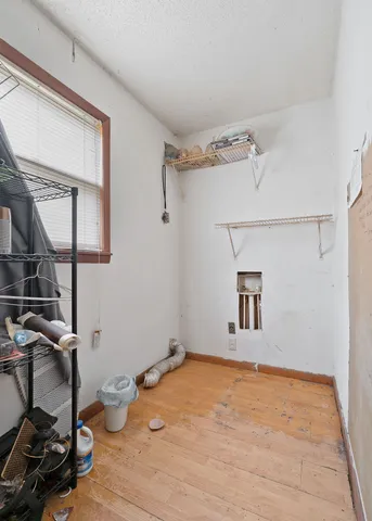 a view of a room with wooden floor and bathroom