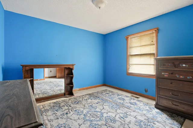 a bedroom with a bed and a dresser