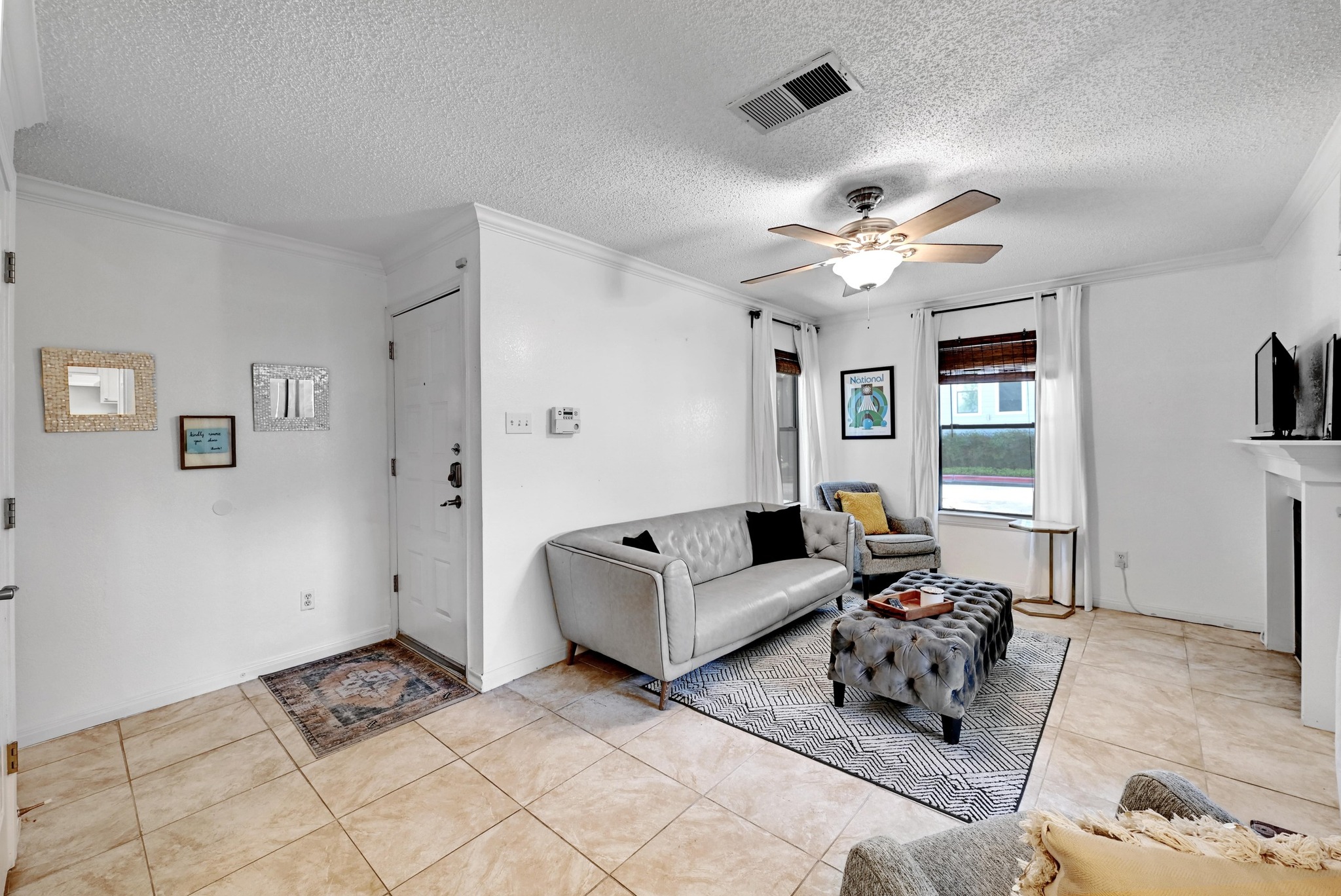 7635 Guadalupe Street, Unit 1002 Austin, TX 78752 - Photo 7 of 27 a living room with furniture and a ceiling fan