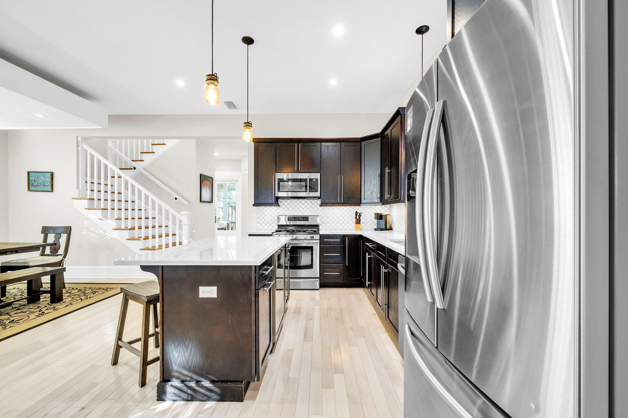 13 Eastern Lake Court Santa Rosa Beach, FL 32459 - Photo 15 of 58 a kitchen with kitchen island a counter top space a sink stainless steel appliances and cabinets