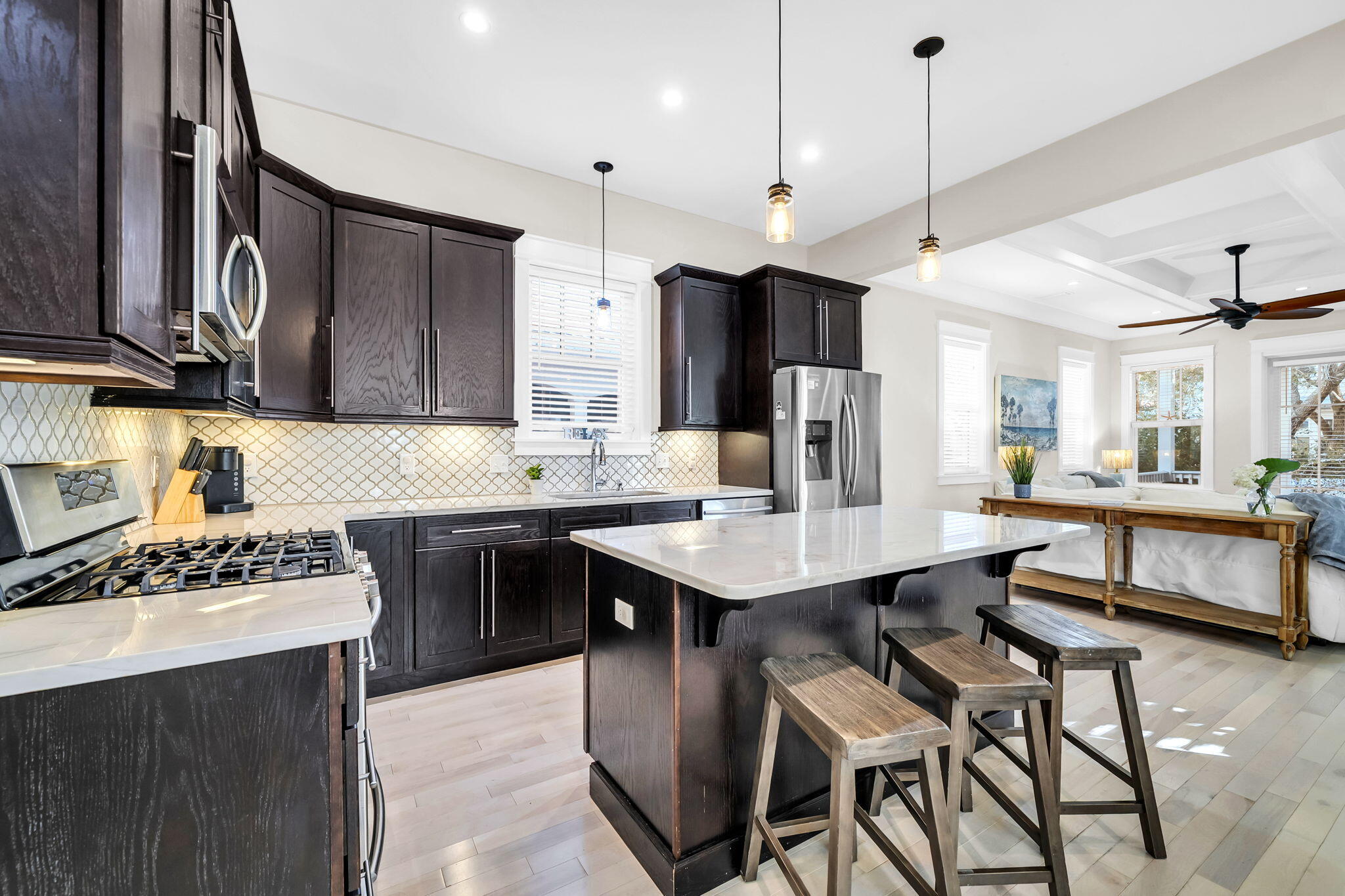 13 Eastern Lake Court Santa Rosa Beach, FL 32459 - Photo 17 of 58 a kitchen with stainless steel appliances kitchen island a table chairs in it and wooden floors