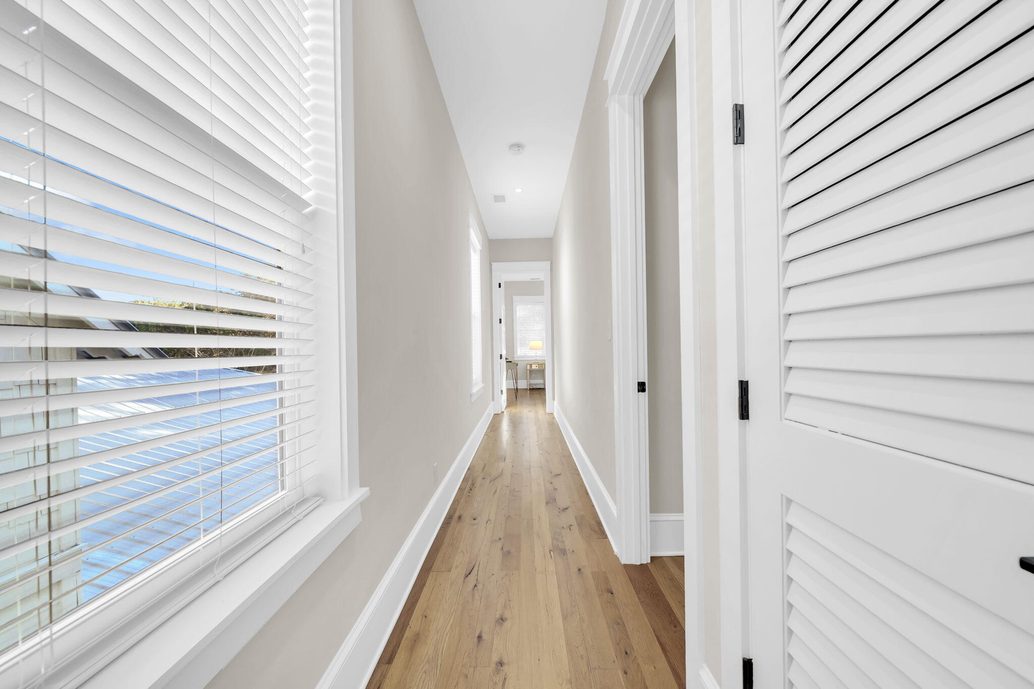 13 Eastern Lake Court Santa Rosa Beach, FL 32459 - Photo 36 of 58 a view of a hallway with wooden floor and staircase