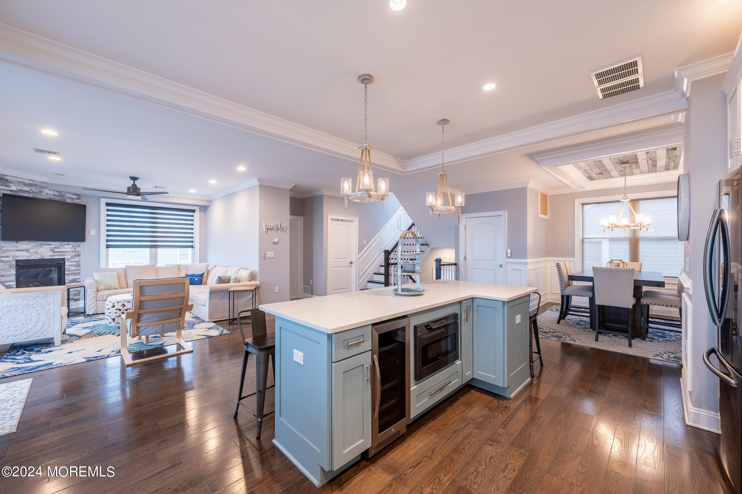 1851 Oceanfront Seaside Heights, NJ 08751 - Photo 15 of 66 a kitchen with stainless steel appliances granite countertop a stove top oven a dining table and chairs with wooden floor