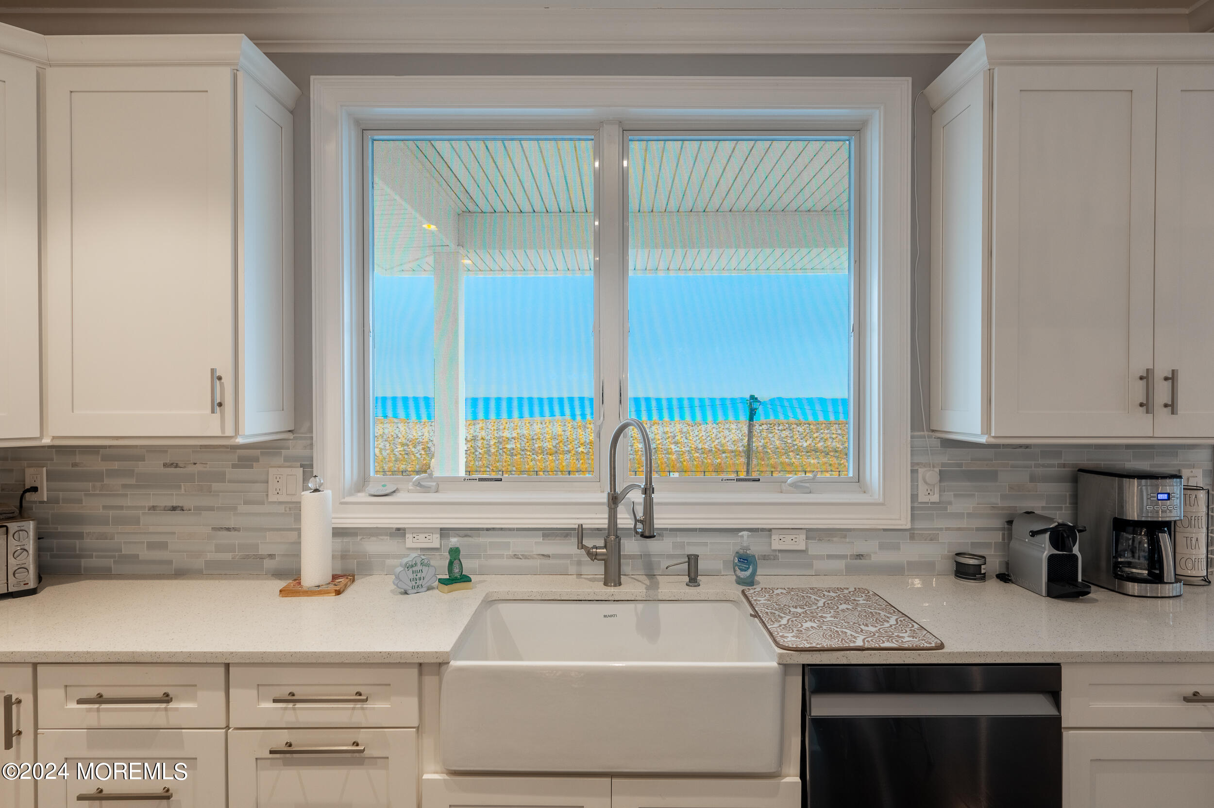 1851 Oceanfront Seaside Heights, NJ 08751 - Photo 16 of 66 a kitchen with granite countertop a sink and a window
