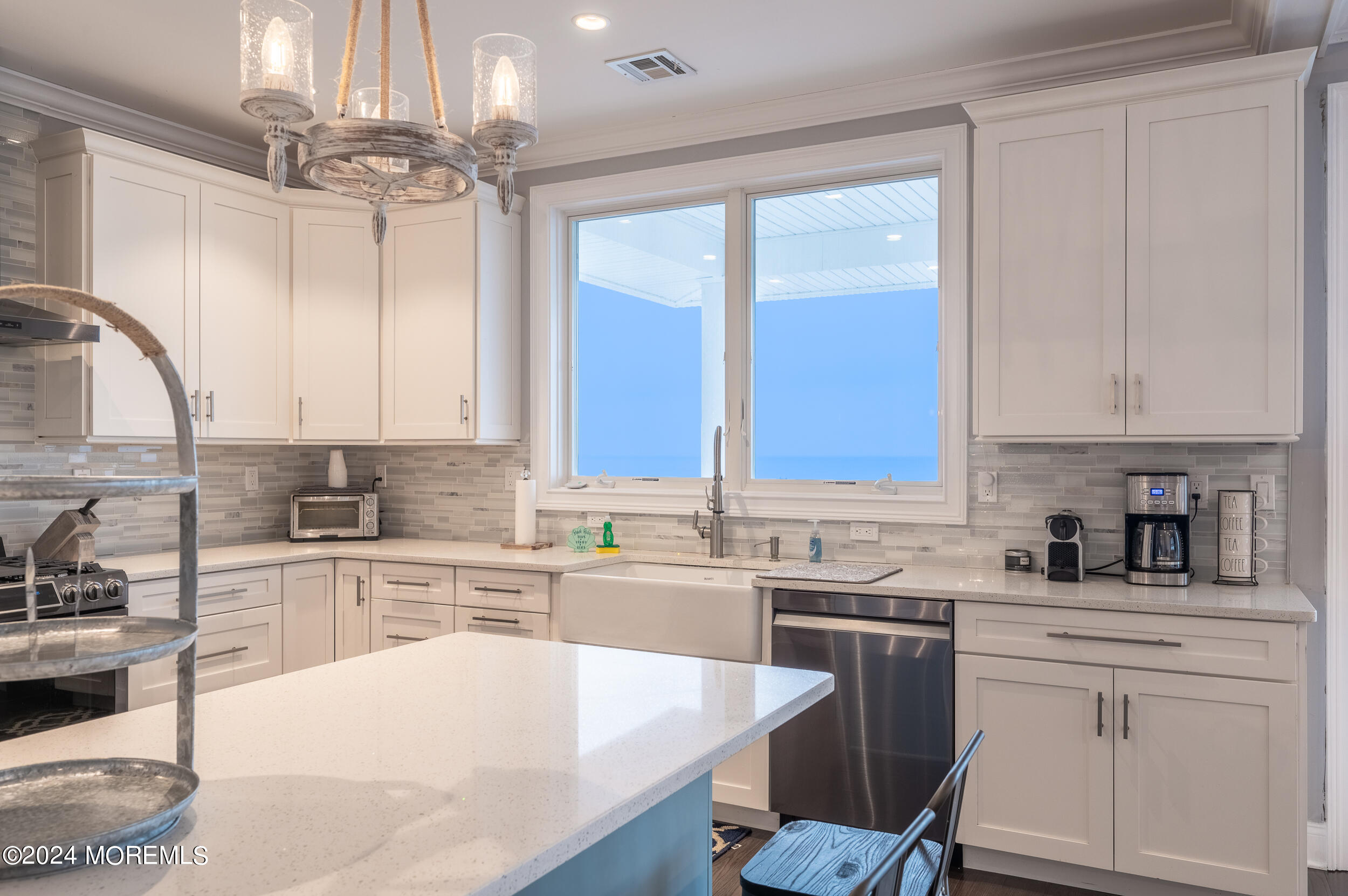1851 Oceanfront Seaside Heights, NJ 08751 - Photo 17 of 66 a kitchen with a sink cabinets stainless steel appliances and a window