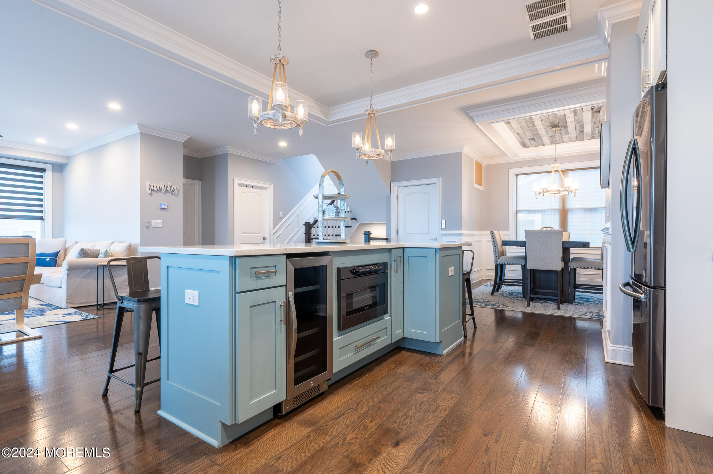 1851 Oceanfront Seaside Heights, NJ 08751 - Photo 18 of 66 a kitchen with stainless steel appliances granite countertop a stove top oven a refrigerator a dining table and chairs with wooden floor